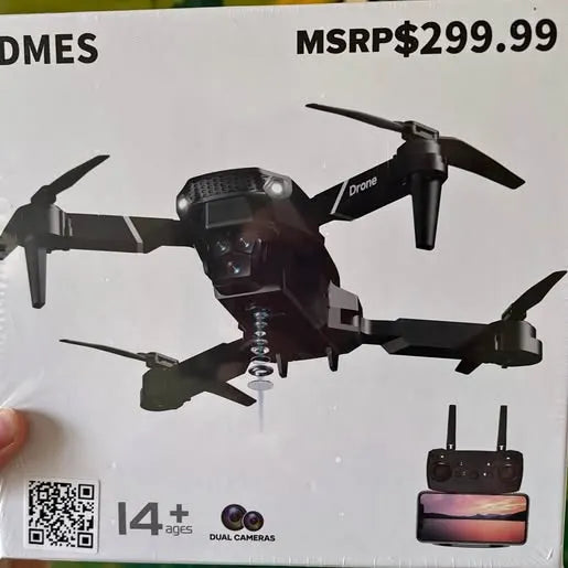 Black quadcopter drone with four propellers and attached camera housing, with remote controller