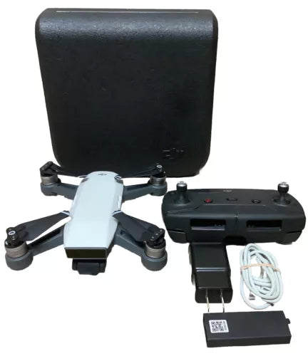 DJI Spark camera drone kit with white drone, remote, battery, cords, and black case