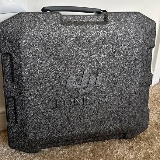 Black DJI Ronin-SC hard camera gimbal case with textured surface and front logo