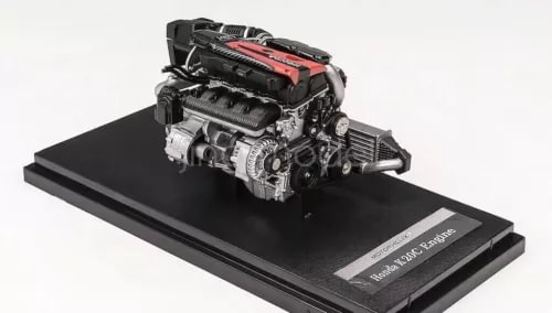 Diecast turbo engine model with red cover, on black display base