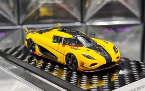Yellow racing sports model diecast car, front 3/4 view with black wheels