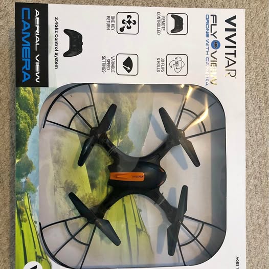 Fly view drone in retail box with four propeller arms visible