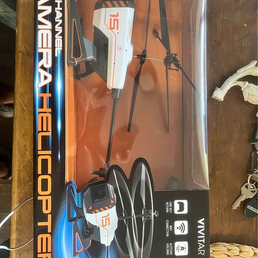 RC drone in retail box, propellers and camera module visible