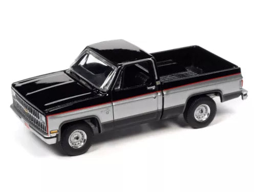 1:64 diecast 1981 Chevy Silverado pickup toy, silver with black hood and bed, front 3/4