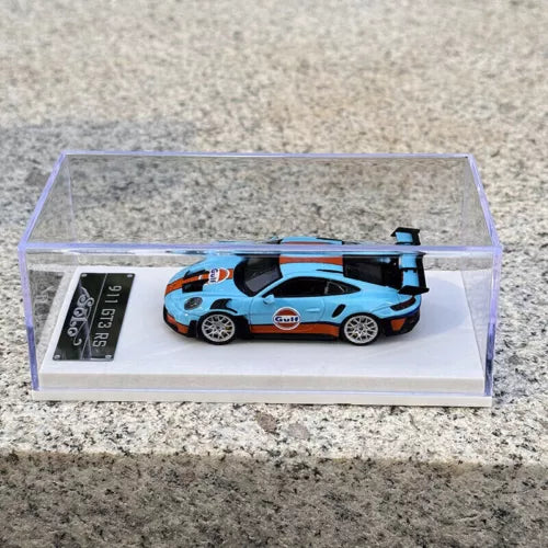 1/64 scale diecast race car model with Gulf orange blue and black livery in display case