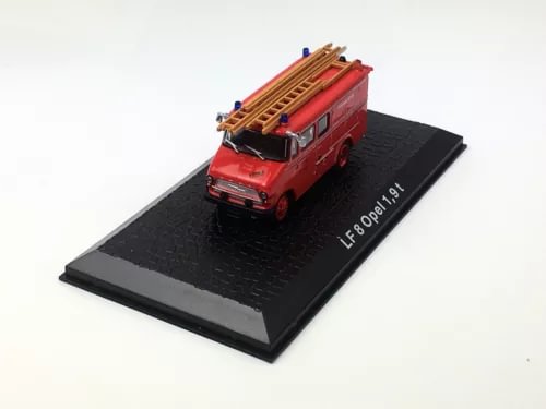 Red diecast fire engine model on black display base
