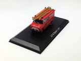 Red diecast fire engine model on black display base