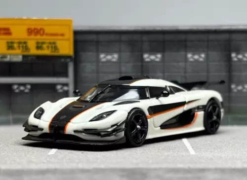 1:64 diecast sports racing car, white with black hood and orange stripes, front view