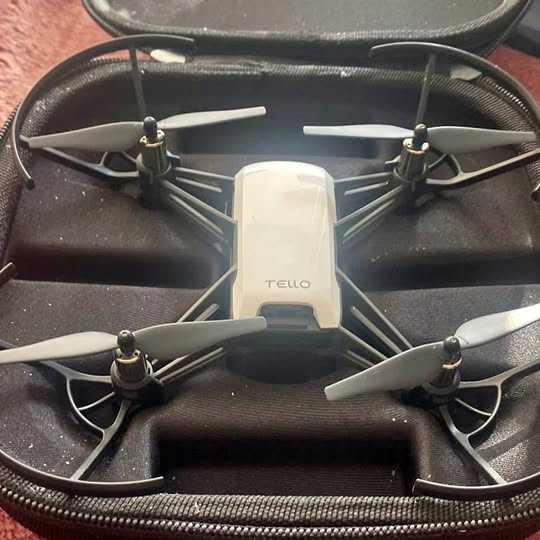 Compact quadcopter drone with four propellers and front camera in hard case