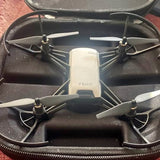 Compact quadcopter drone with four propellers and front camera in hard case