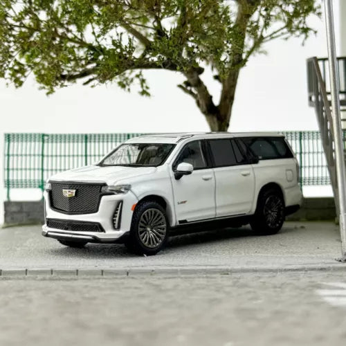 White diecast SUV model car, front three-quarter view, black wheels and grille.