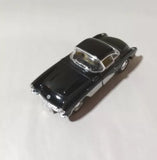 Black 1957 diecast model car, 1:36 scale, glossy hood and chrome details