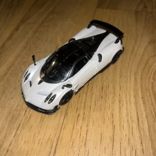 White diecast toy car with black accents, front three-quarter view