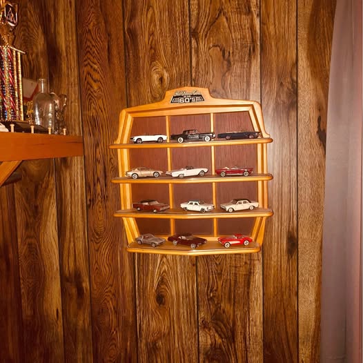 Diecast car display case with multiple model cars on wooden shelves