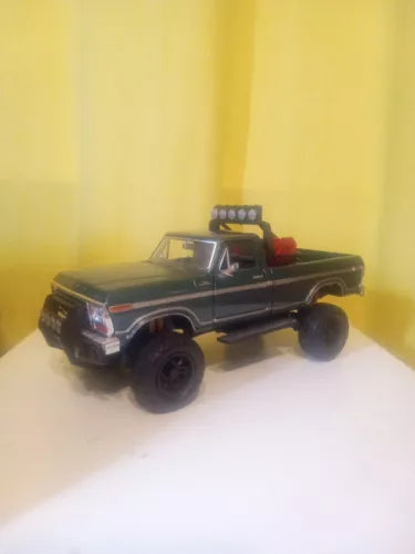 Off-road pickup truck diecast, black with red interior details, oversized tires
