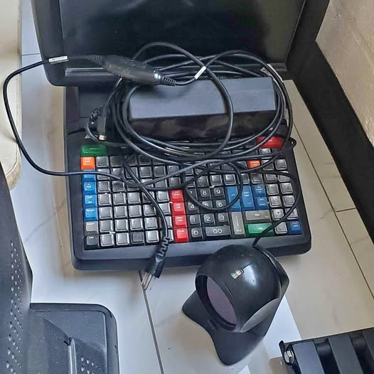 Black computer keyboard with numeric keypad and connected cables, with black mouse