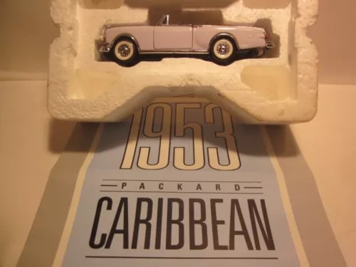 White 1:43 diecast car model in open display box with Caribbean logo