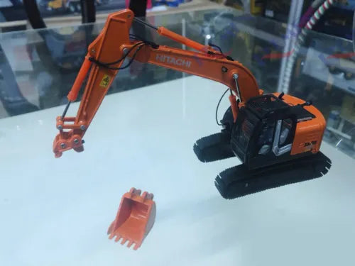Orange 1/50 diecast excavator model with articulated arm and included bucket piece