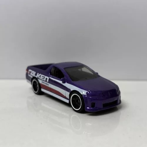 Purple diecast UTE model car with white and red racing stripes, black wheels
