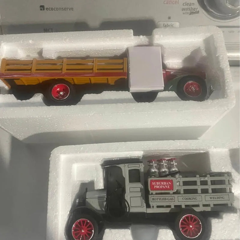 Black diecast model truck with red wheel rims, detailed cab and side decals