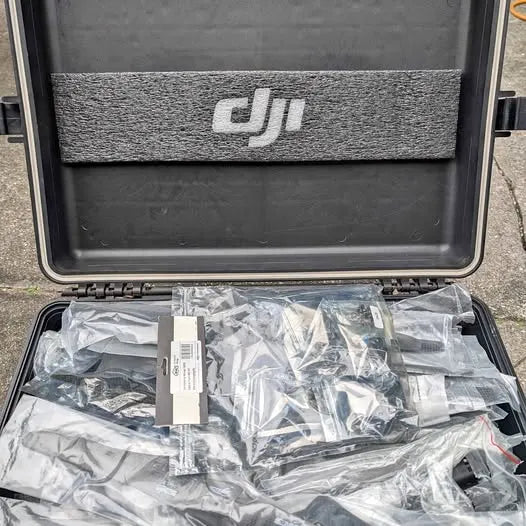 Drone accessory kit in hard case with DJI logo foam and plastic-wrapped parts
