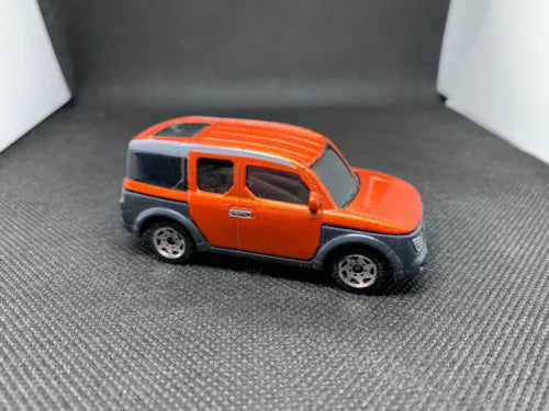 Orange 1:64 diecast SUV with black windows and gray wheels, side view