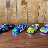 Four diecast race cars, blue and yellow with racing numbers and sponsor decals