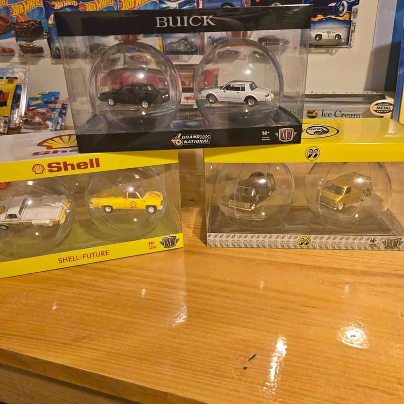Diecast model car in clear blister packaging, yellow car with white car details
