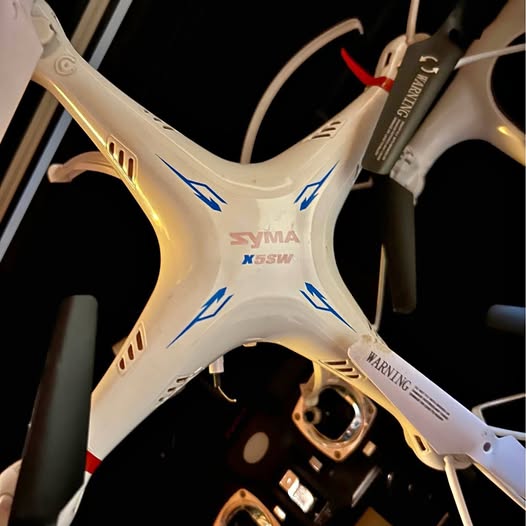 White quadcopter drone body with SYMAX markings and four propeller arms