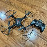 Drone with camera and controller, dark teal quadcopter with four propeller arms