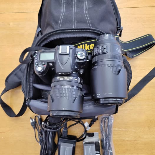 Nikon D90 camera kit with multiple lenses in carrying bag