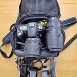 Nikon D90 camera kit with multiple lenses in carrying bag