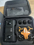 Foldable mini RC quadcopter drone kit in open hard case with controller and props