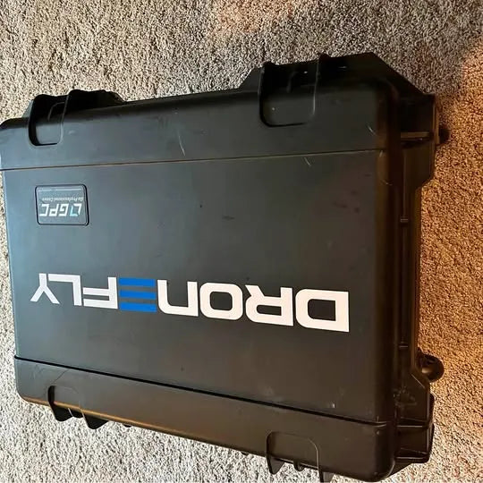 Hard-shell drone carrying case with blue and white DRON logo