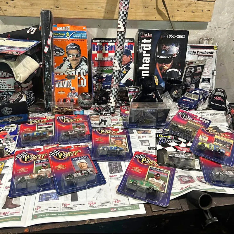 NASCAR diecast car and memorabilia set with boxed cars, hats, and posters