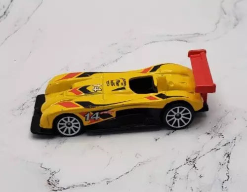 Yellow diecast race car with black wheels, black side decals, and red rear spoiler