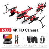 Mini drone with red quadcopter body, 4K HD camera, and visible remote and batteries