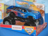 Blue and black die-cast monster truck in retail box, visible wheels and cab