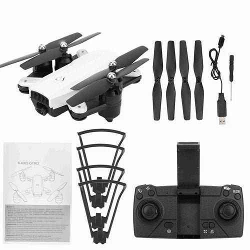 White folding RC drone with controller, spare propellers, USB cable and manuals.