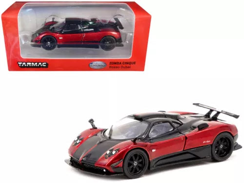 Red and black diecast supercar model with black aero details, in display case