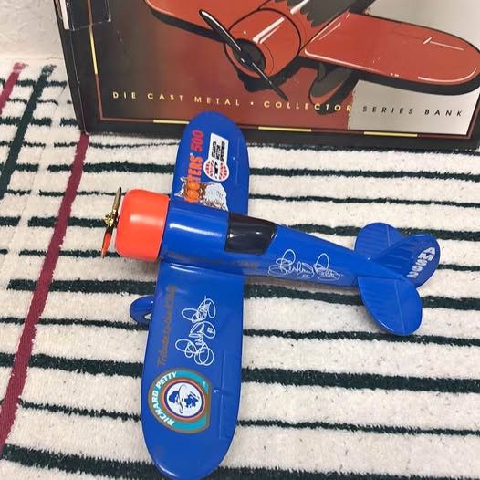 Diecast airplane model 1/24 in blue with red nose and propeller, side logo detail