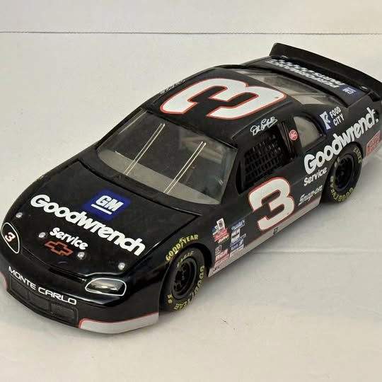 Black race car diecast model with red number 3 and Monte Carlo styling