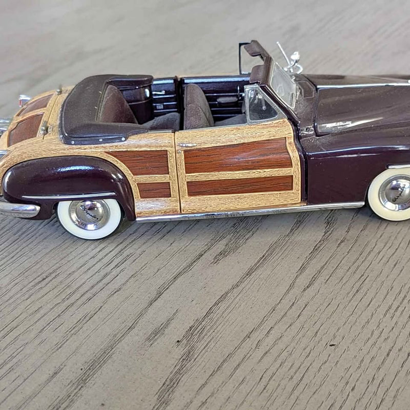 Maroon diecast convertible car model with gold stripe and light wood side panels