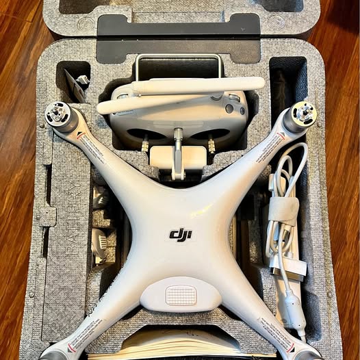 DJI Phantom 4 Pro drone in open case, white quadcopter with four arms and camera housing