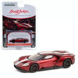 Red 1:64 diecast sports car toy with black wheels, shown in blister pack