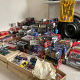 Diecast car model collection, assorted packaged vehicles in retail boxes