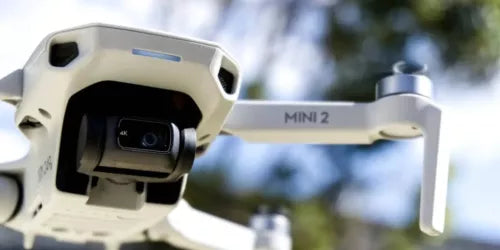 White DJI Mini 2 drone with front camera and motorized gimbal, front view