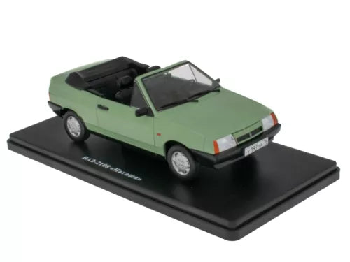 Light green diecast miniature convertible car with black roof on display base