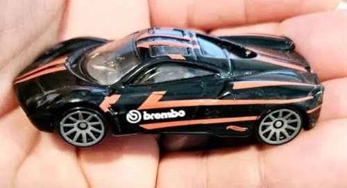 Hot Wheels Pagani Huayra diecast car, black with orange stripes and Brembo logo