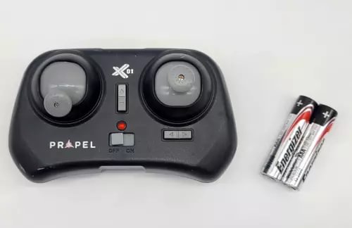 Black wireless quadcopter remote controller with X01 marking and AA battery